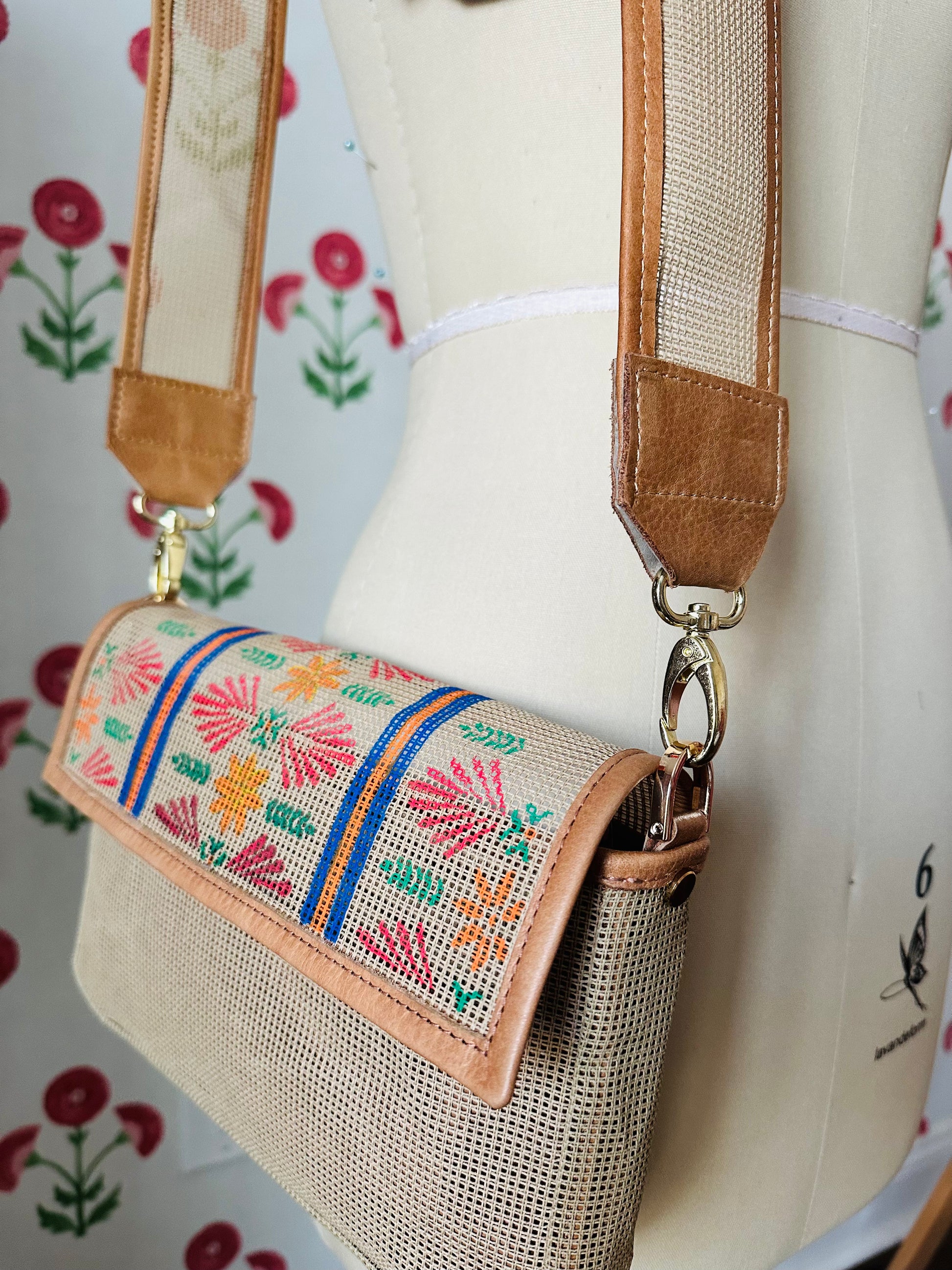 The long needlepoint crossbody strap