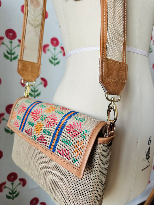 The long needlepoint crossbody strap